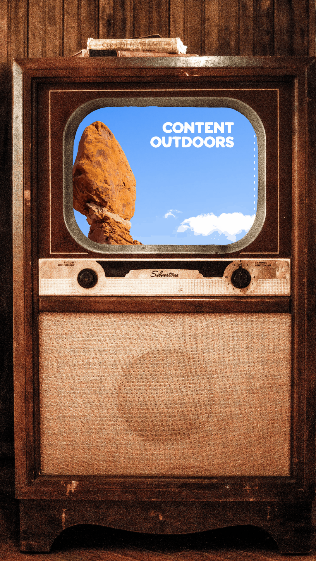 A video of an old tv with a website scrolling where the screen was. A cursor pointer clicks the play button and a snowboarder turns in front of an orange Yeti cooler